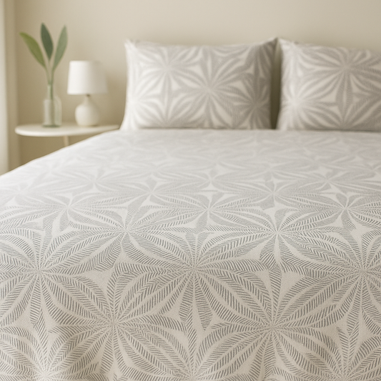 Bed with textured bedding and pillows in a bedroom setting