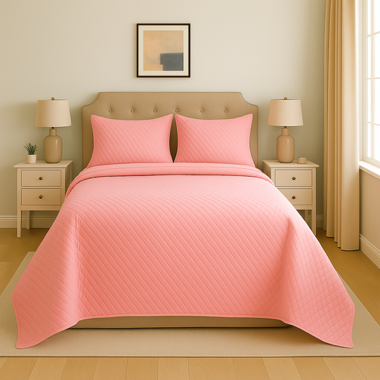 Bedroom with pink quilt and pillows on a bed, two nightstands with lamps, and a framed picture on the wall.
